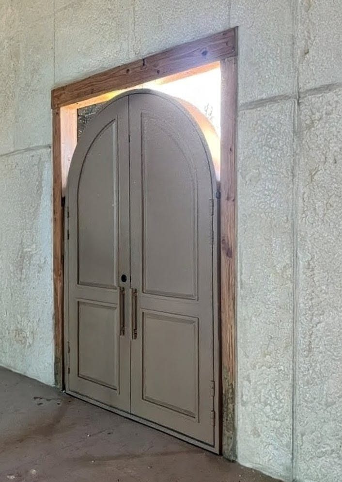Arched double iron door entrance